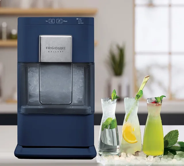 Blue Frigidaire Gallery nugget ice maker beside three iced drinks on a kitchen counter