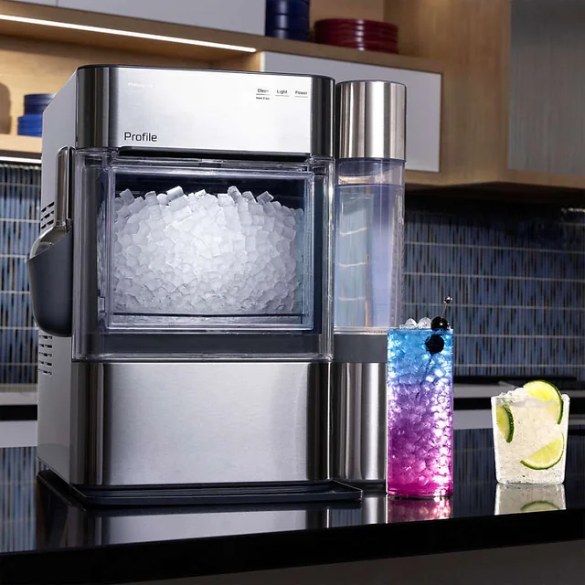 Stainless steel GE Profile Opal 2.0 Ultra nugget ice maker with side water tank on a kitchen counter
